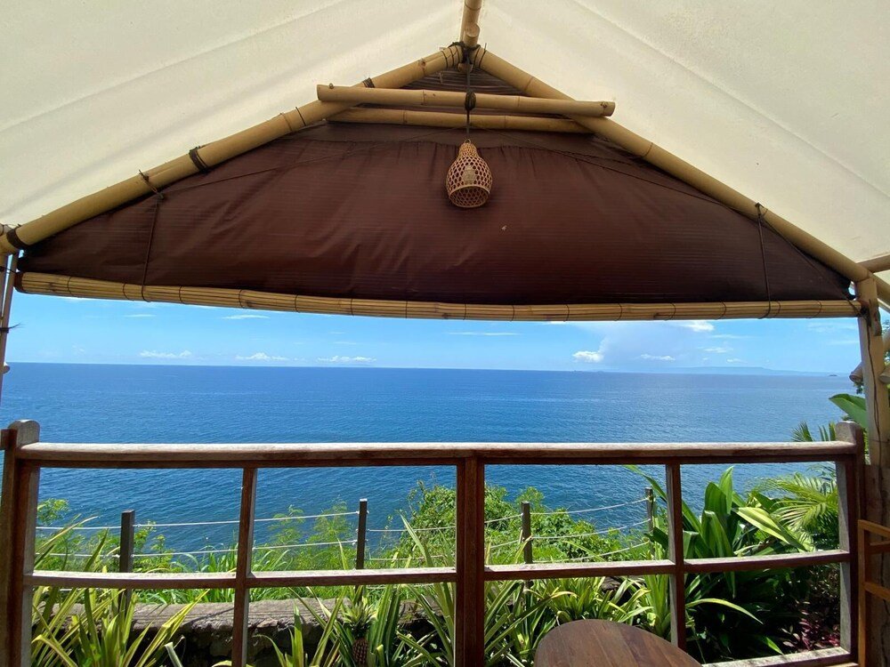 Guest tent interior with bedding at Bali Cliff Glamping, Bali