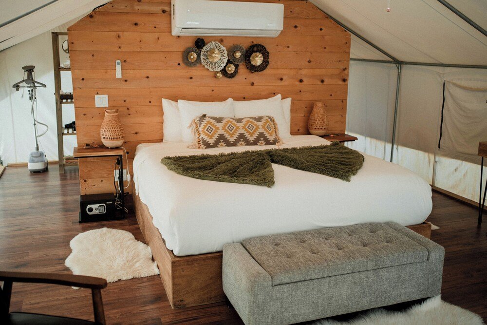 Interior of a glamping tent at Casa Misiones with bedding and decor