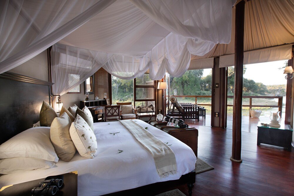 Interior of a luxury safari tent with bed at Hamiltons Tented Camp