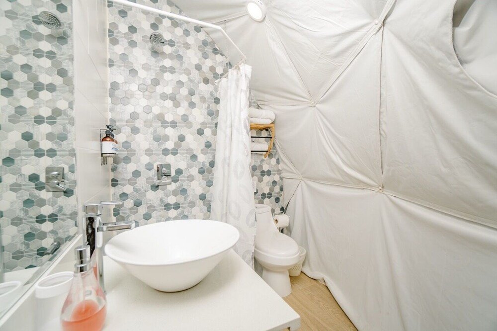 Private bathroom with rainfall shower at Tortuga Verde Glamping